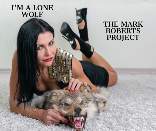 Girl laying on a Rug with a Stuff Wolf.
